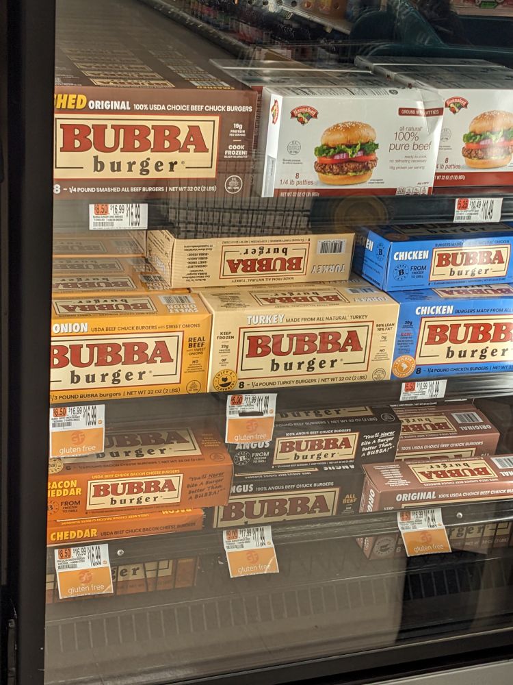 A freezer case in a grocery store full of Bubba brand frozen hamburger patties. 