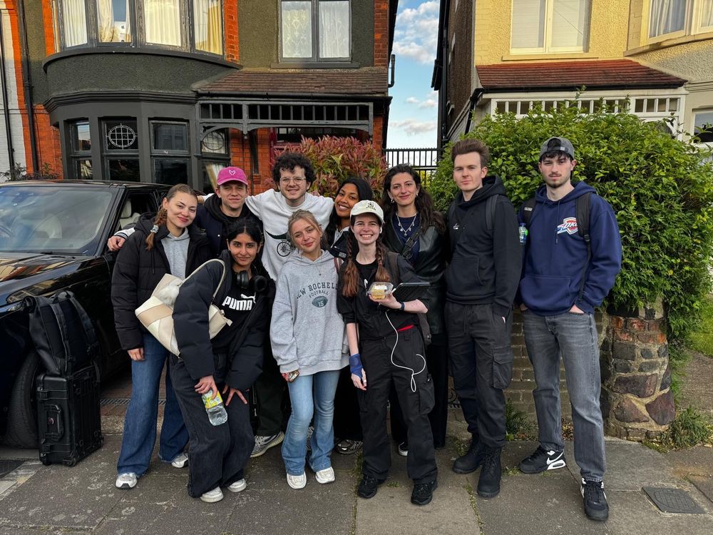 10 of the crew members of the short film “A Figment of Existence” outside their shooting location on the last filming day. They are all tired but smiling.