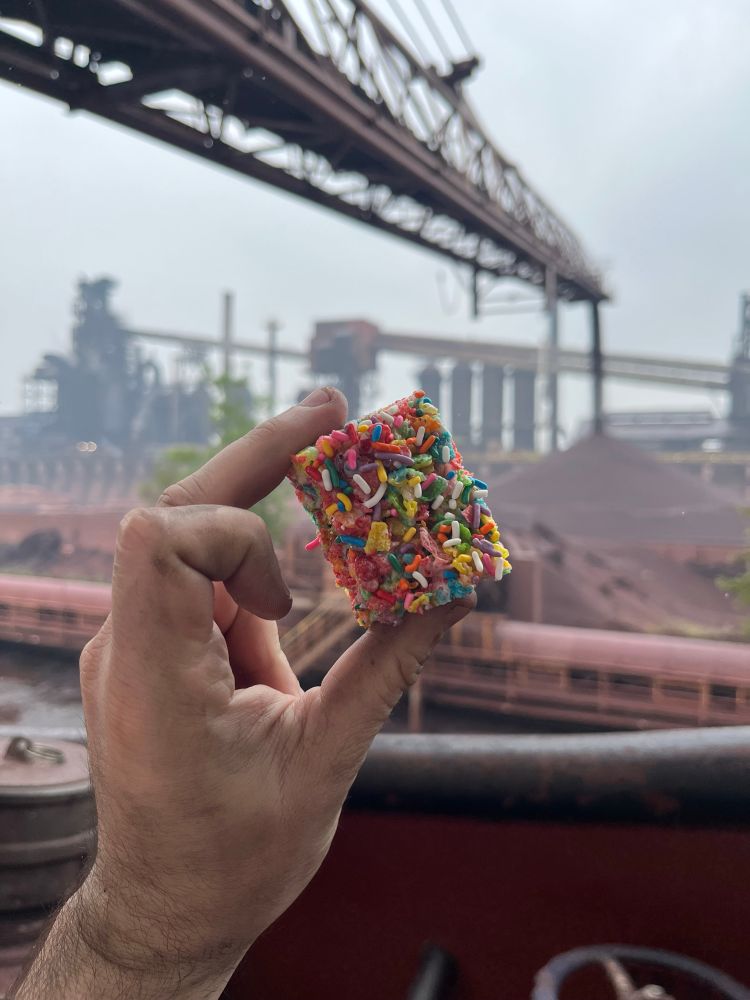 I am holding what appears to be a congealed brick of fruity pebbles and sprinkles. It tastes like what I assumed L’oreal shampoo would taste like as child and has the consistency of Legos whose DNA has collapsed. In the distance, 30,000 tons of taconite drops off of a conveyor belt to be smelted and turned into molten steel.