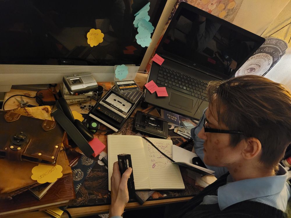 Cosplay compilation picture of Jonathan Simms the Head Archivist of The Magnus Archives surrounded by notes and recorders. Hidden eye themes for The Watcher.