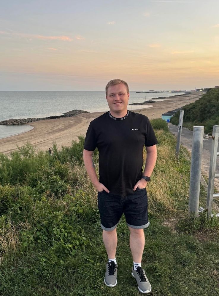 Cameron standing in front of a beach