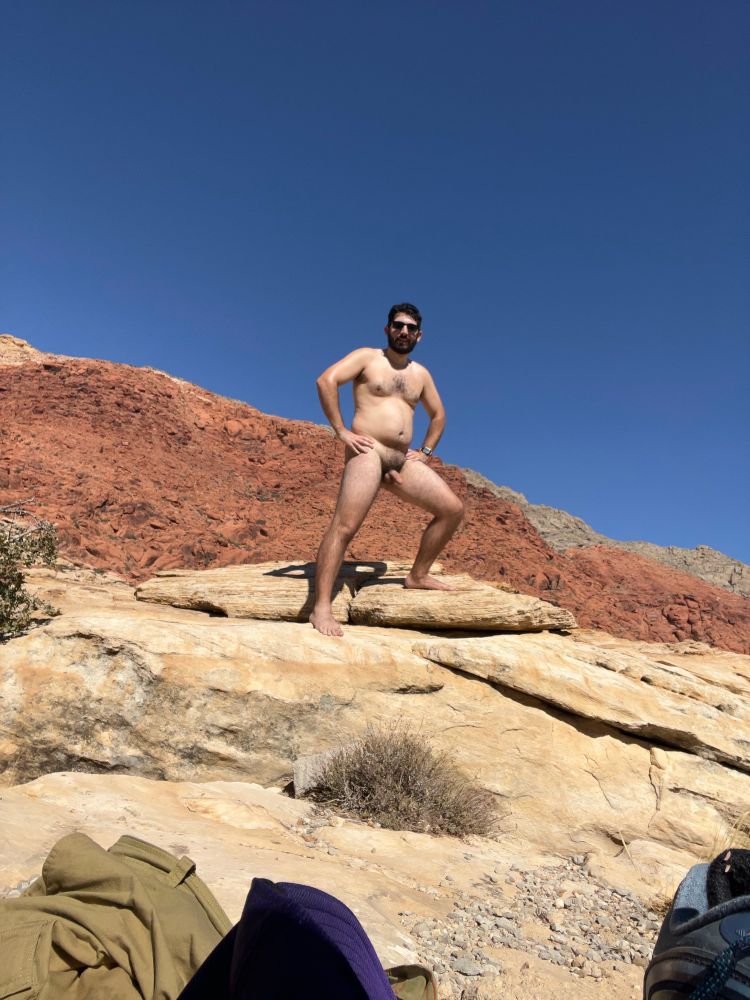 Ma standing naked in red rock canyon