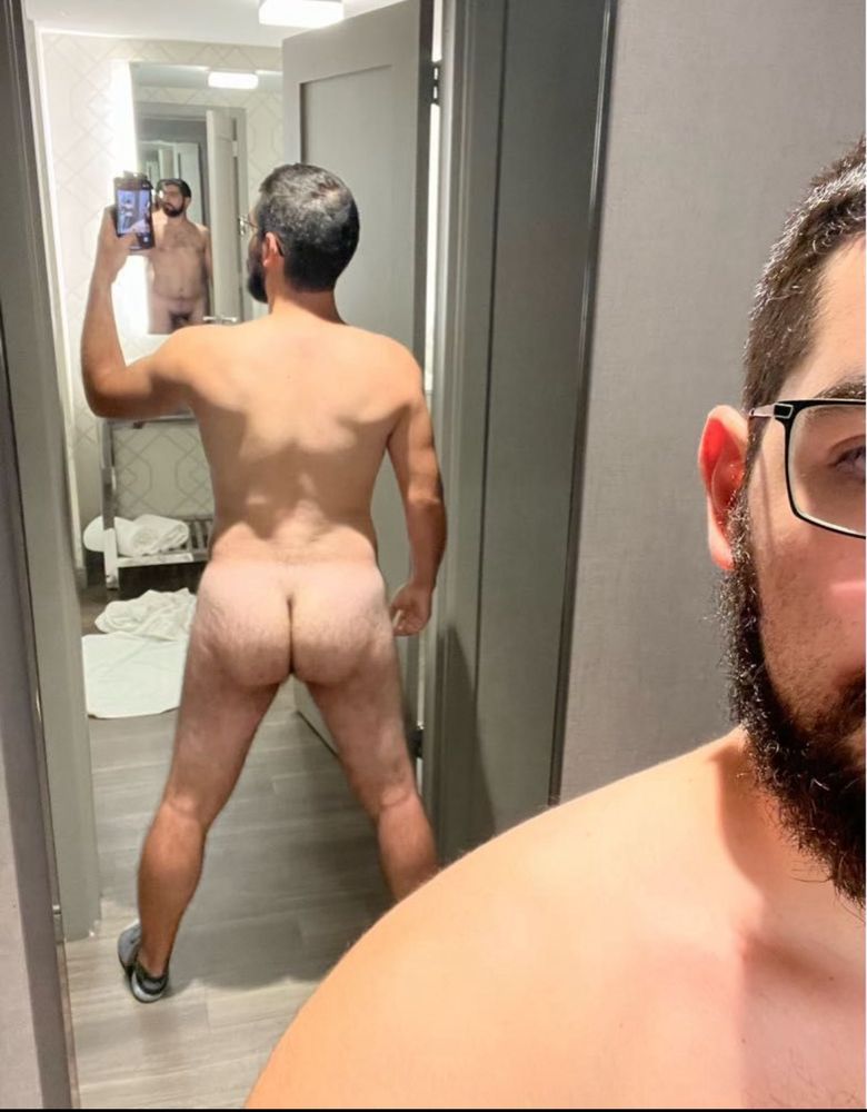 Standing naked in front of a floor length mirror showing off my butt