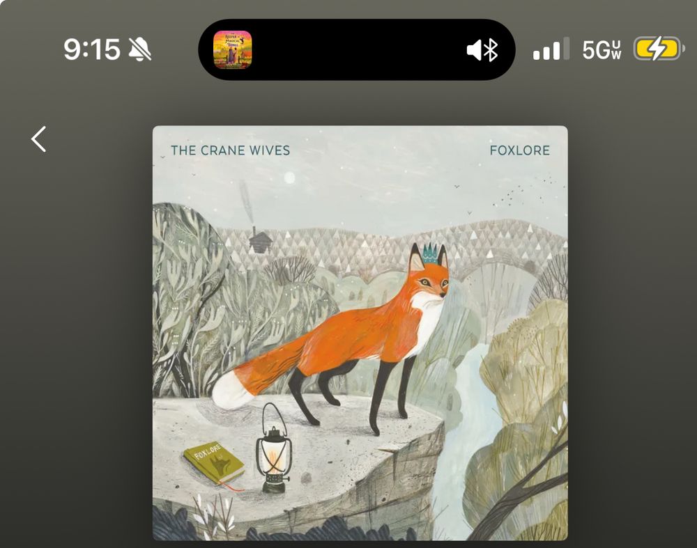 The FOXLORE album cover which has a fox in a teal crown beside a lantern 