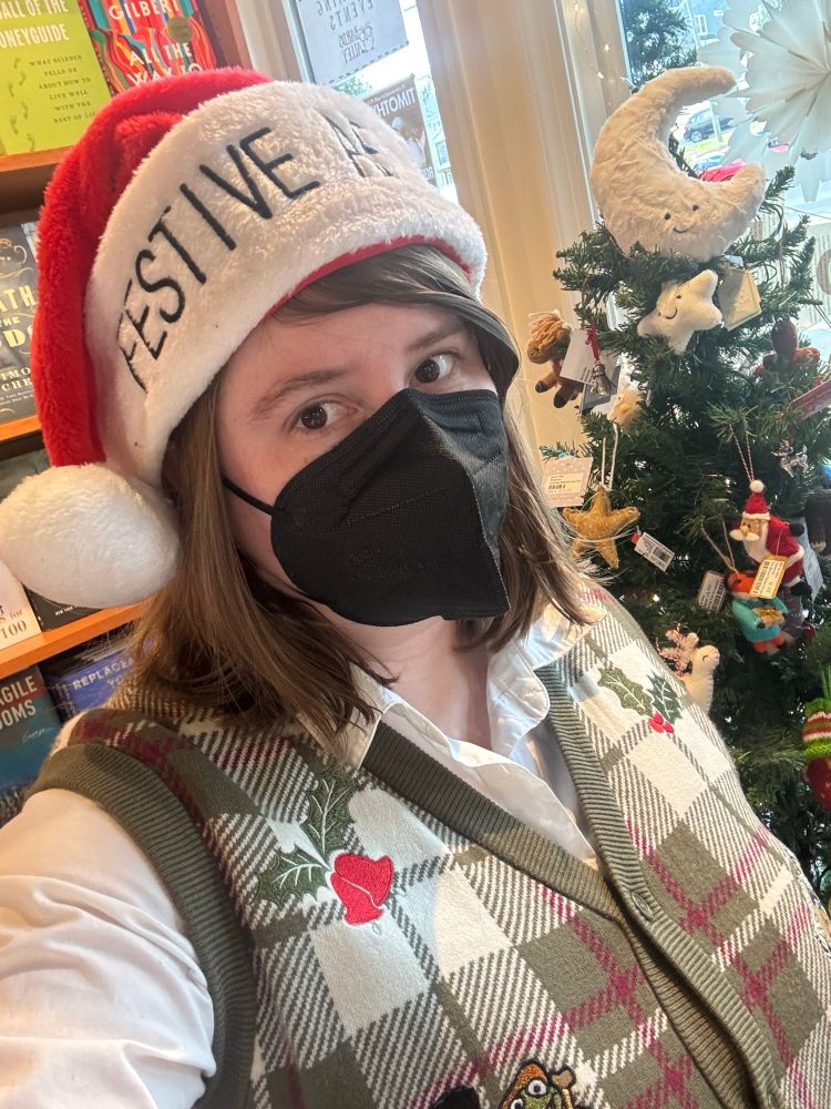 A selfie of me in a Santa hat that reads FESTIVE AF