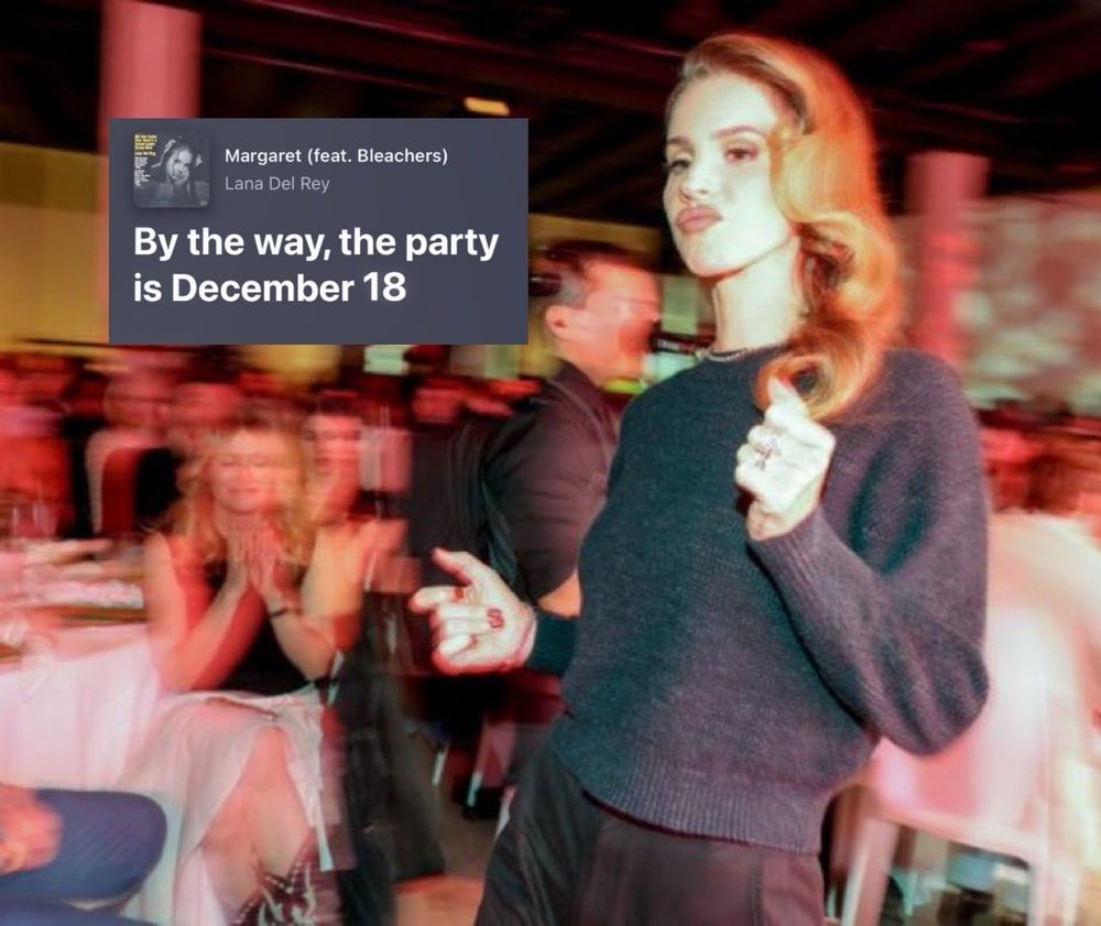 Lana Del Rey in a gray sweater and black trousers with lyrics from the song, Margaret, that read, "By the way, the party is December 18." 