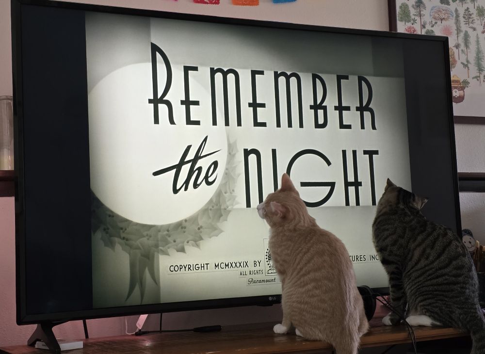 Paco and Larry in front of the title screen for Barbara Stanwyck in Remember The Night