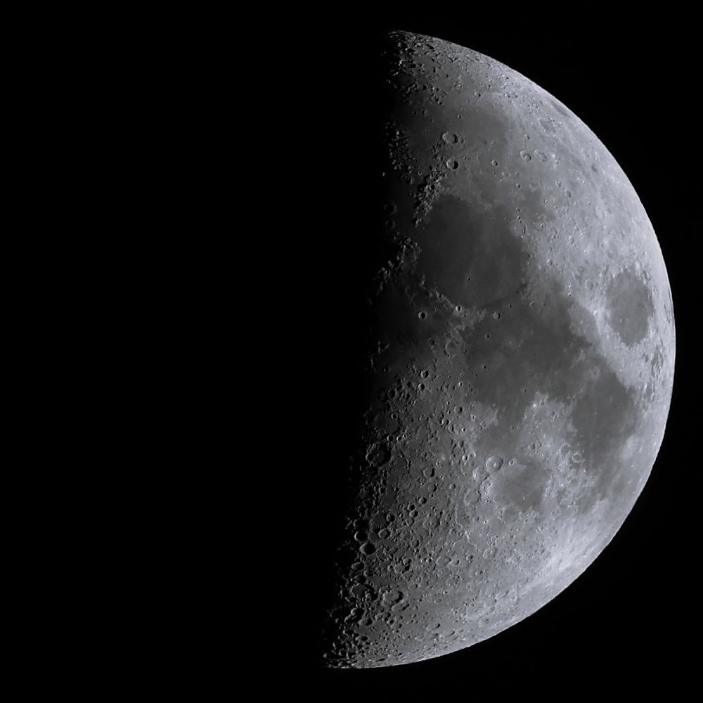 B&W photo of recent (30 Aug 2025) First Quarter moon. Many craters and maria (mares) can be seen. The background is the blackened void of space.
