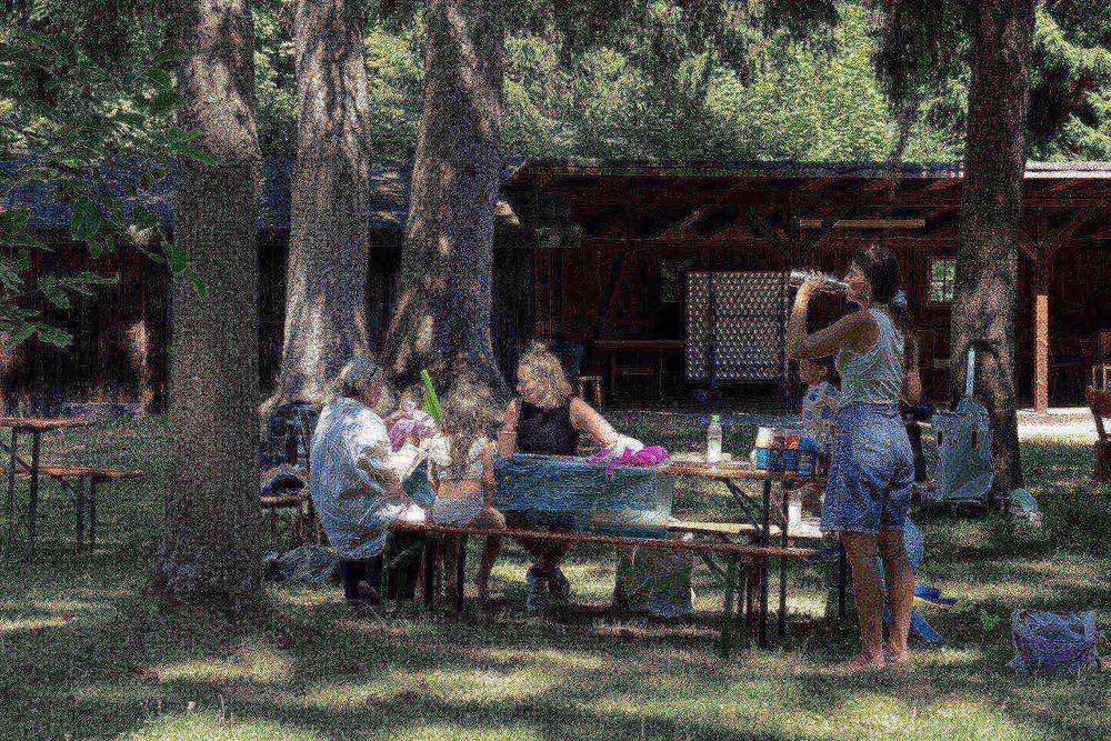 a group of people sitting at a picnic table