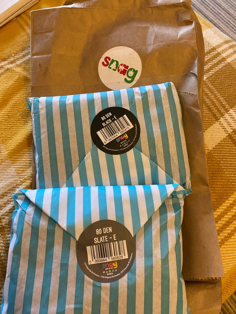 Two blue and white striped paper bags labelled with Black 80 denier and Slate 80 denier. Delivered in a brown paper parcel