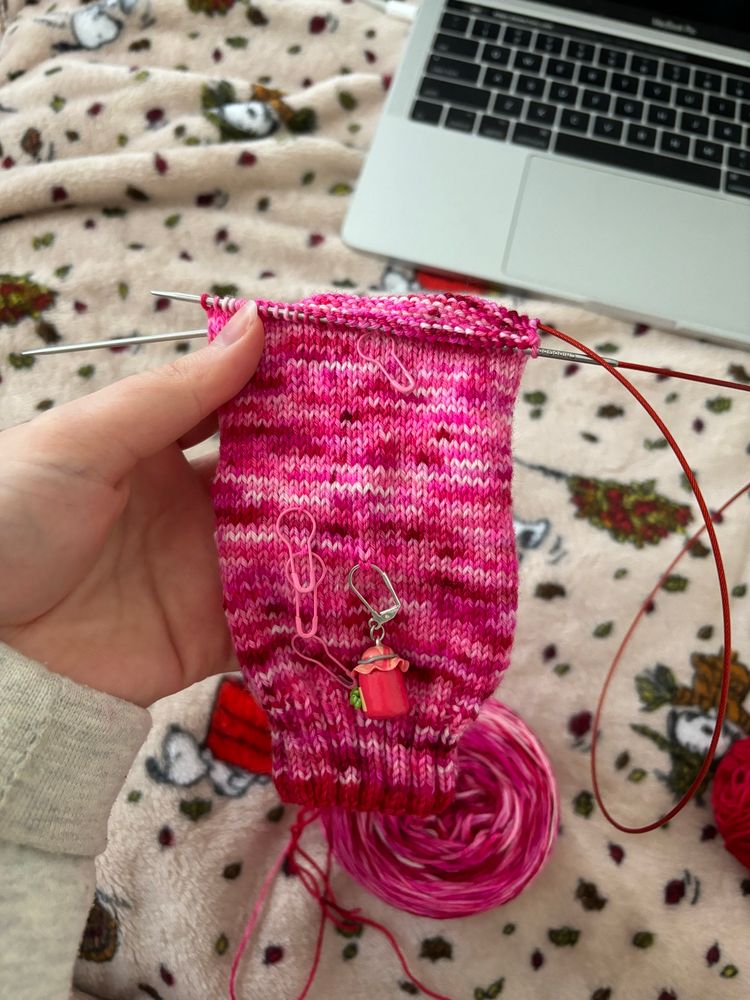a progress picture of a hand knit pink variegated sock that’s about halfway finished