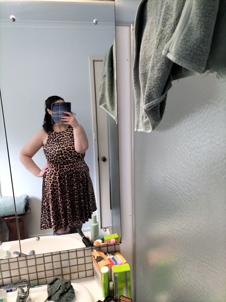 Me in a sleeveless leopard-print midi dress.