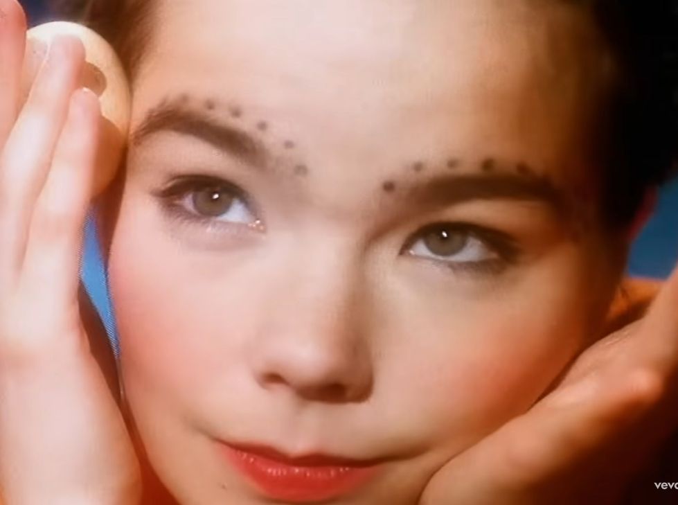 bjork, circa 1993, rolling a different egg along her face