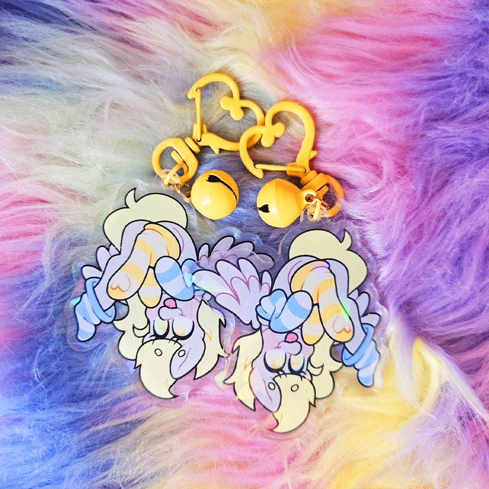 2 charms of the Derpy acrylic charm, wearing yellow and blue socks. 