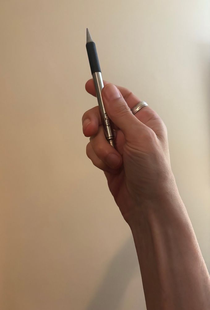 I’m holding up an aged, silvery mechanical pencil. 