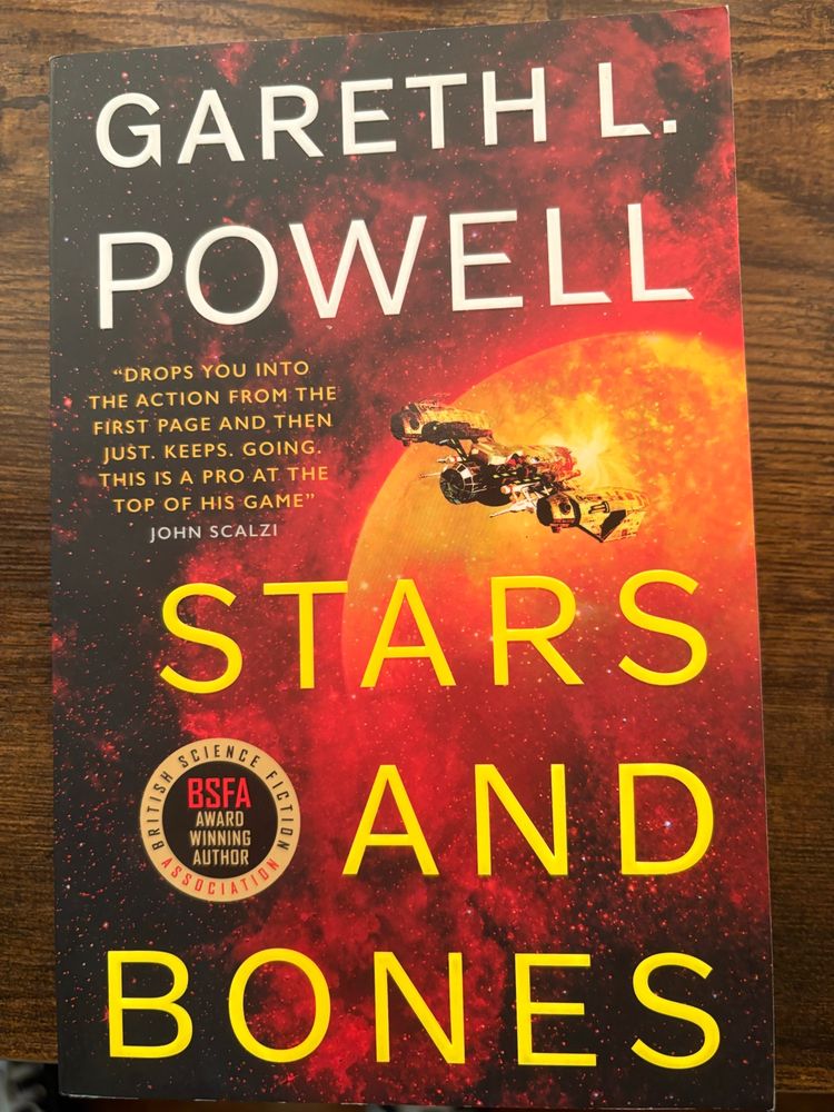 Cover for Gareth L. Powell’s novel Stars and Bones, featuring a spaceship flying across and orange background. 