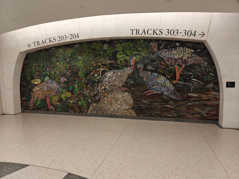 a mosaic art piece depicting jungle animals in the wall of Grand Central Madison