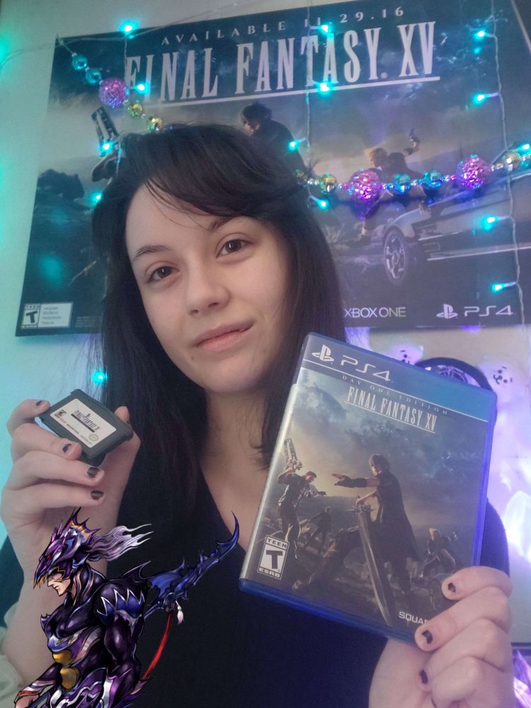 A photo of me, Anima, holding a two video games; in my left hand I’m holding the Final Fantasy XV Day One Edition case, in my right hand I’m holding my childhood Final Fantasy IV game boy advance cartridge. In the photo I’m wearing a black sweater, my hair is straight & dark brown & I’m smiling at the camera. In the background on the wall are some Christmas ornaments & lights & a poster of Final Fantasy XV. There’s also a small png of Kain Highwind in the lower left hand corner of the photo