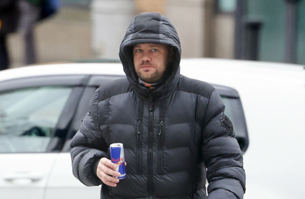Gurrier wearing puffer jacket, carrying a can of redbull. 