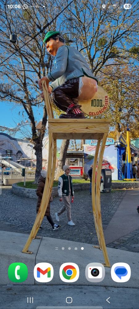 Geldscheisser statue, Prater, Vienna. Man on stool shitting a large gold coin