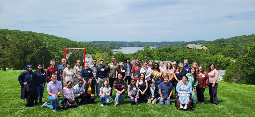 Group photo of attendees at the Midwest Research Skills Development Workshop at Big Cedar Lodge. Photo is taken with the lake in the background.