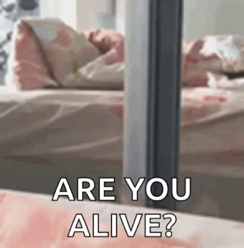 a person laying on a bed with the words `` are you alive '' written on it .