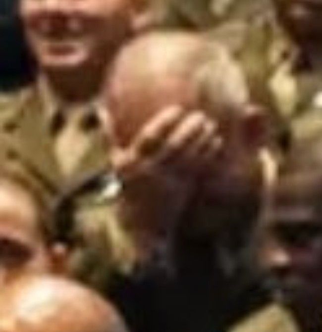 A top US military leader attending Hegseth's meeting doing facepalm.