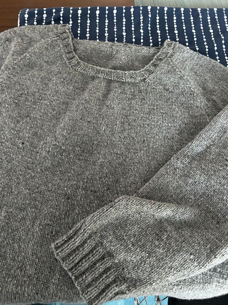 gray handknit raglan sweater that is Too Big for the knitter