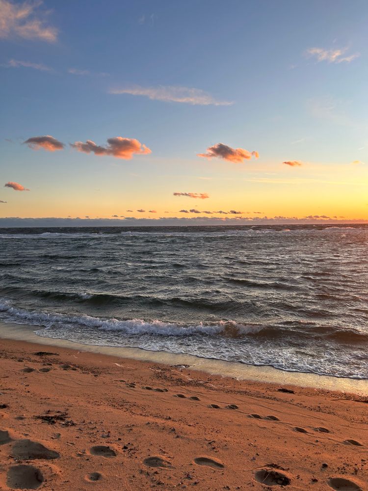 gold light, pink fluffy clouds, angry sea