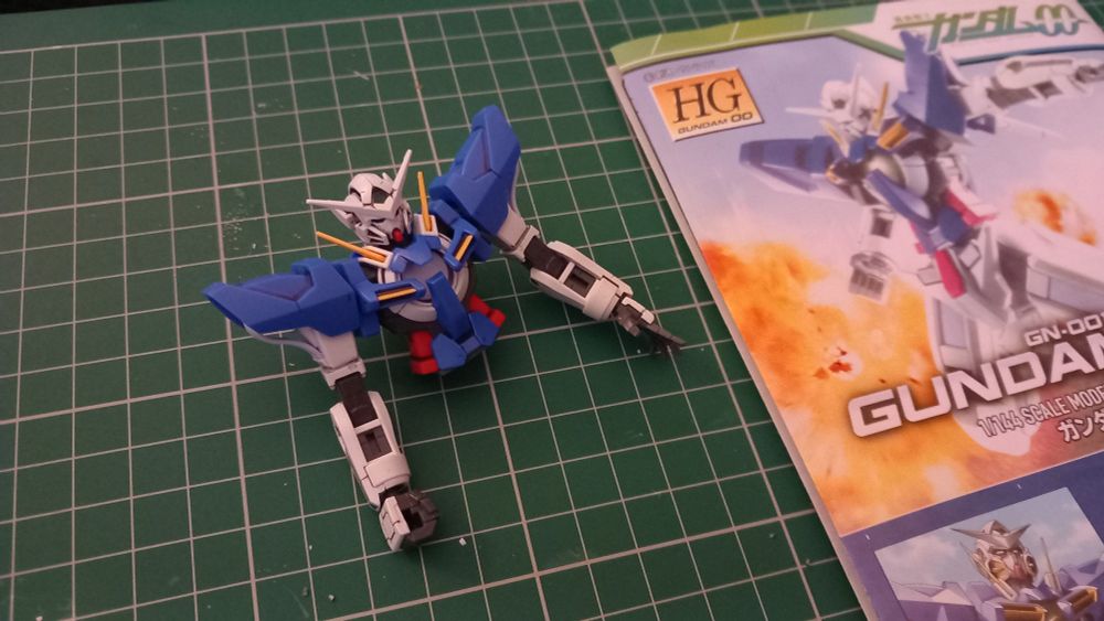 The torso of the HG Exia, next to its manual.