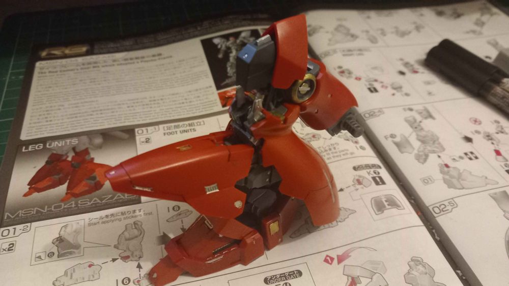 The left side of the RG Sazabi's right leg. It is bent over with the front ankle plate folded up