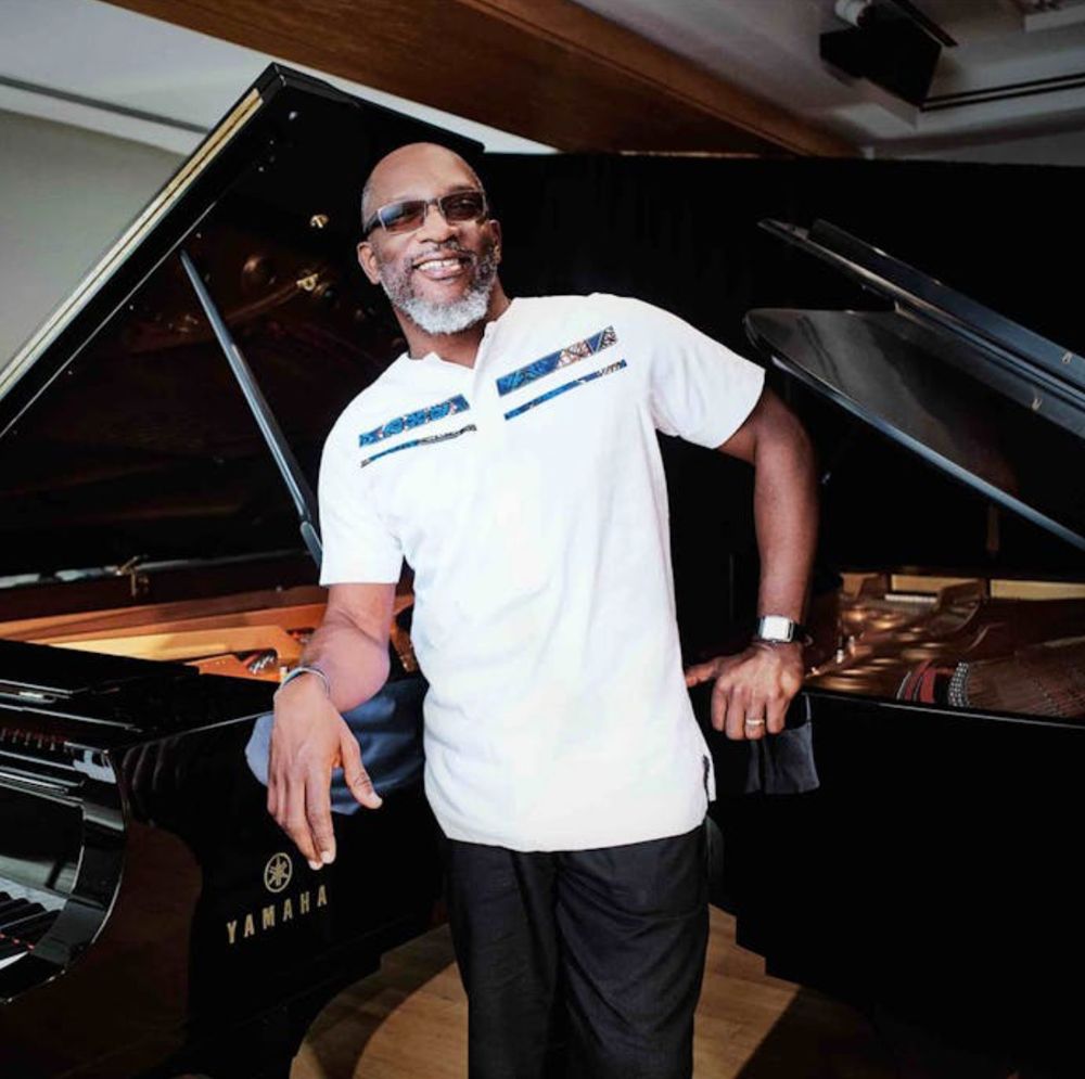 Orrin Evans in front of a Piano