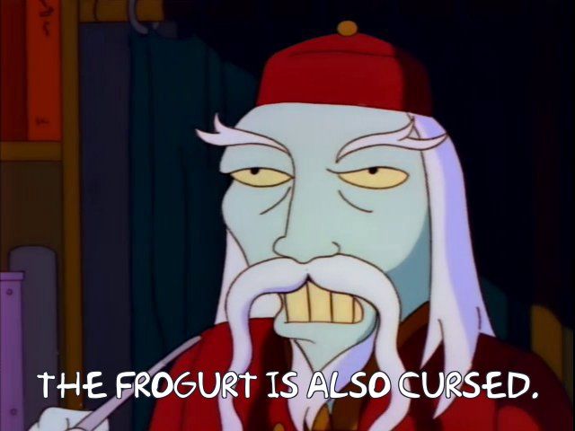 Screenshot from The Simpsons of a wisened old shopkeeper, warning: "The frogurt is also cursed."