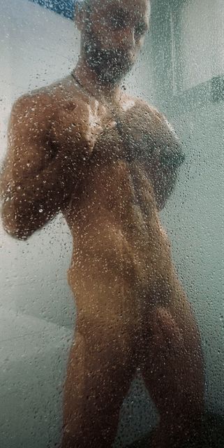 Hairy lean man in shower 