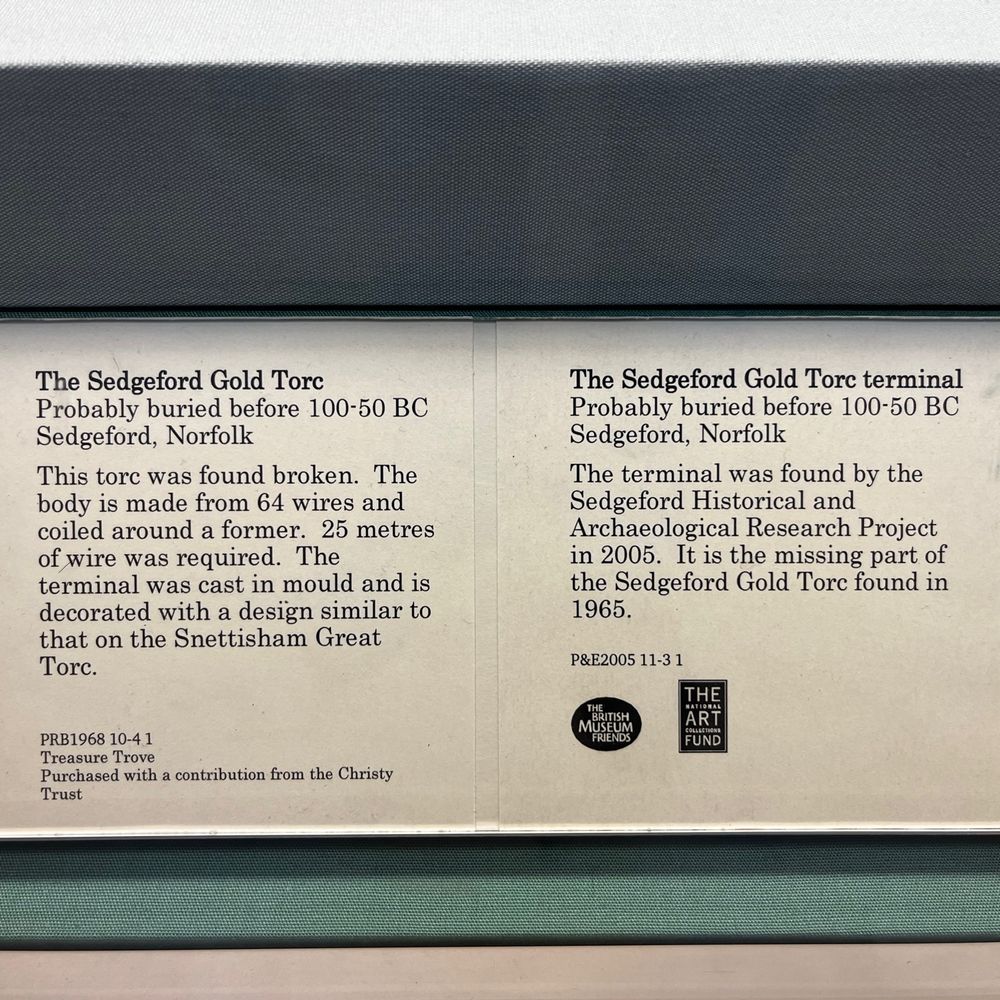 Info panel from the British Museum. The Torc has 64 wires coiled around a former, with 25 metres in total used. The termini were cast in a mould and are similar to the Snettisham Great Torc. It dates to 100-50 BC. The Torc was found broken, with it first discovered in 1965, and the missing terminal found in 2005.
