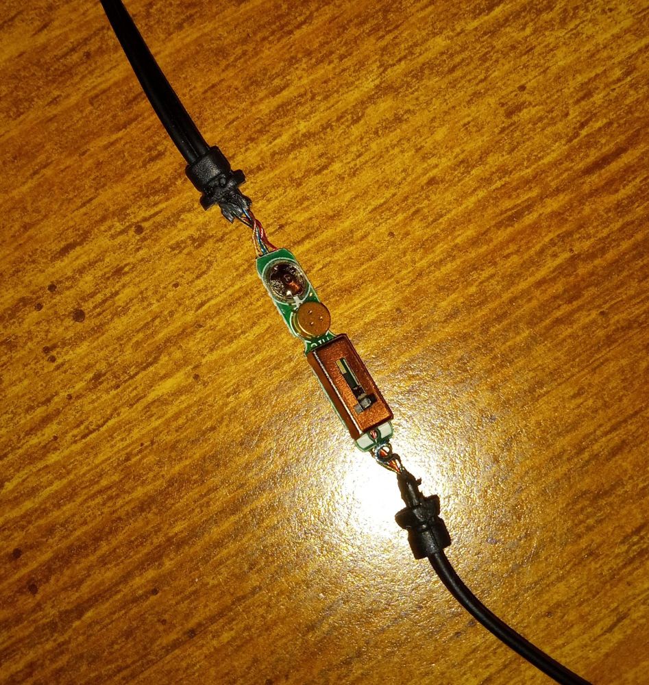 Shot of the exposed remote on a table, showing the circuitry beneath.