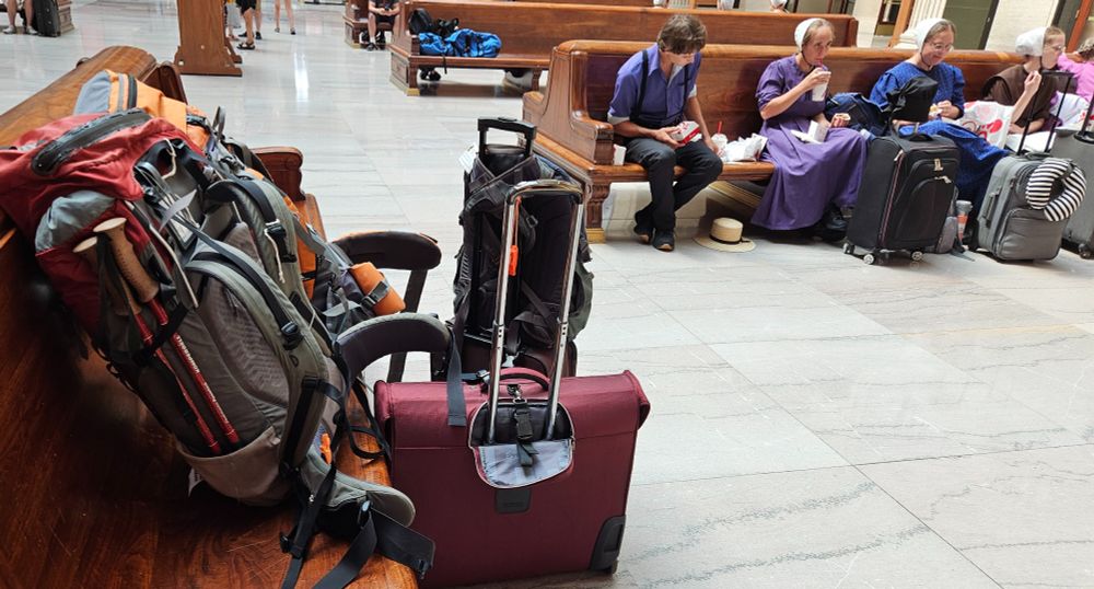 Luggage for both business travel and backpacking piled in the waiting room at Chicago Union Station.