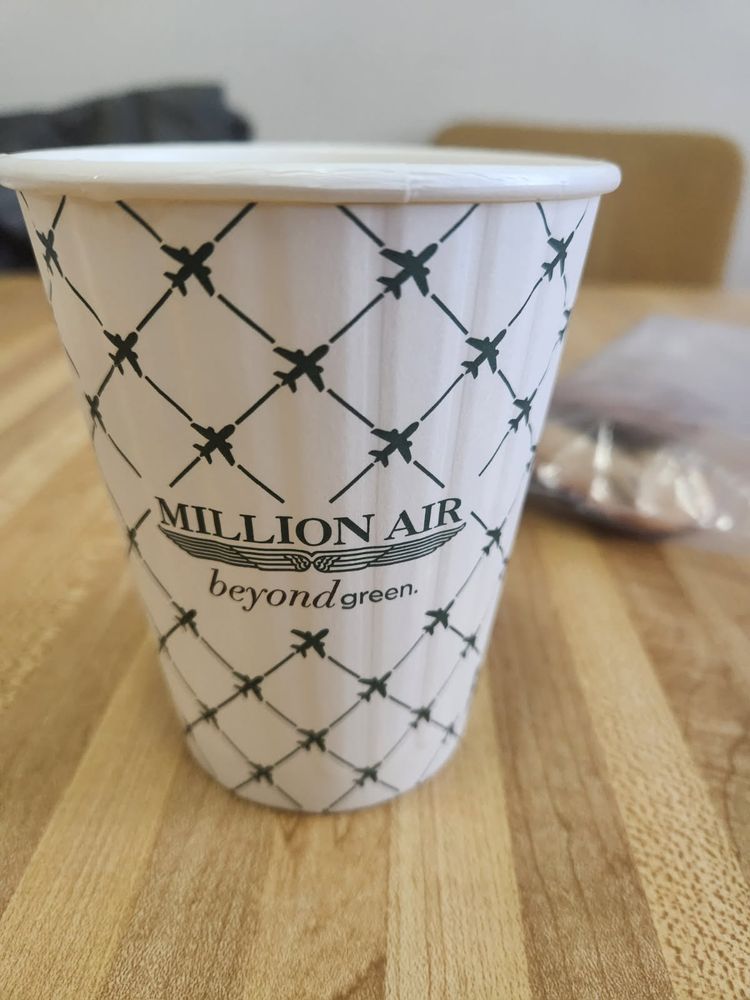 Cup with writing: million air, beyond green 