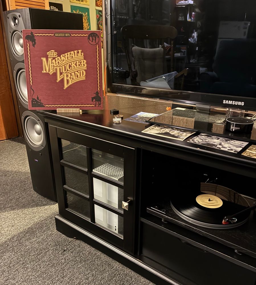 https://www.discogs.com/release/8325407-The-Marshall-Tucker-Band-Greatest-Hits

Record playing on a U-Turn Orbit Theory turntable w/Ortofon 2M Bronze cartridge. The album jacket is displayed on entertainment center.