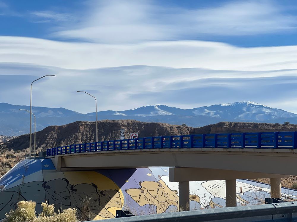 Snow in high mountains (Sangres) blue sky with long clouds and mural underpass
