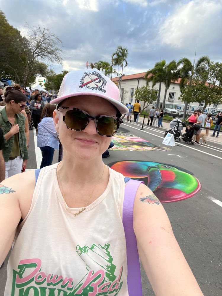 woman in sunglasses, baseball hat with florida panthers logo, tank top that says down bad crying at the gym bc this was my hour of exercise yesterday 