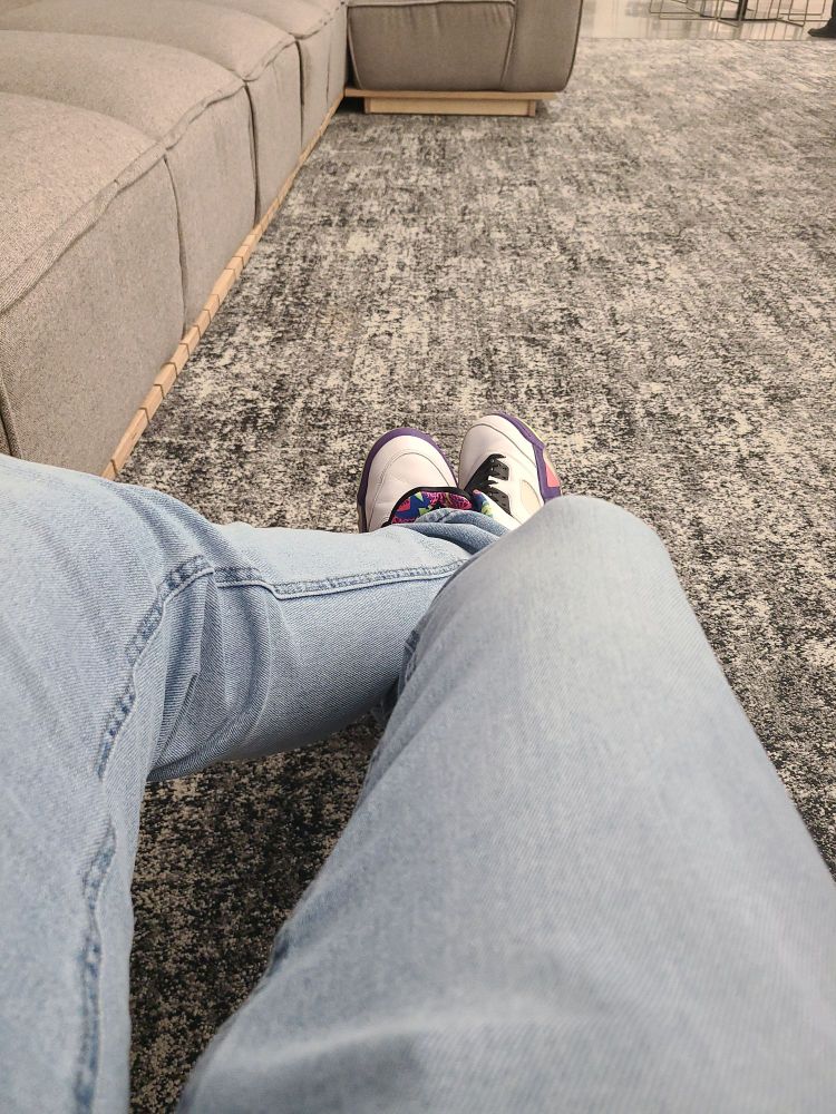 My legs with jeans on and on my feat are the Air Jordan 5 Alternate Bel-Air. In an office setting where I don't get a desk