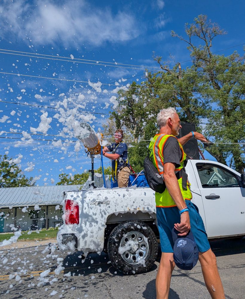 A parade walker getting hit with a foam cannon 
