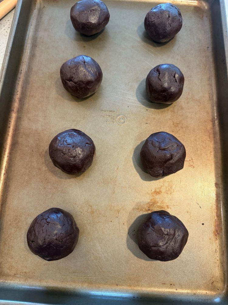 Chocolate dough balls on a pan