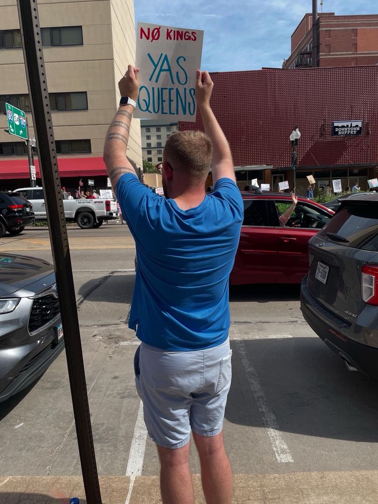 Photo of me holding a protest sign in Lincoln, Nebraska