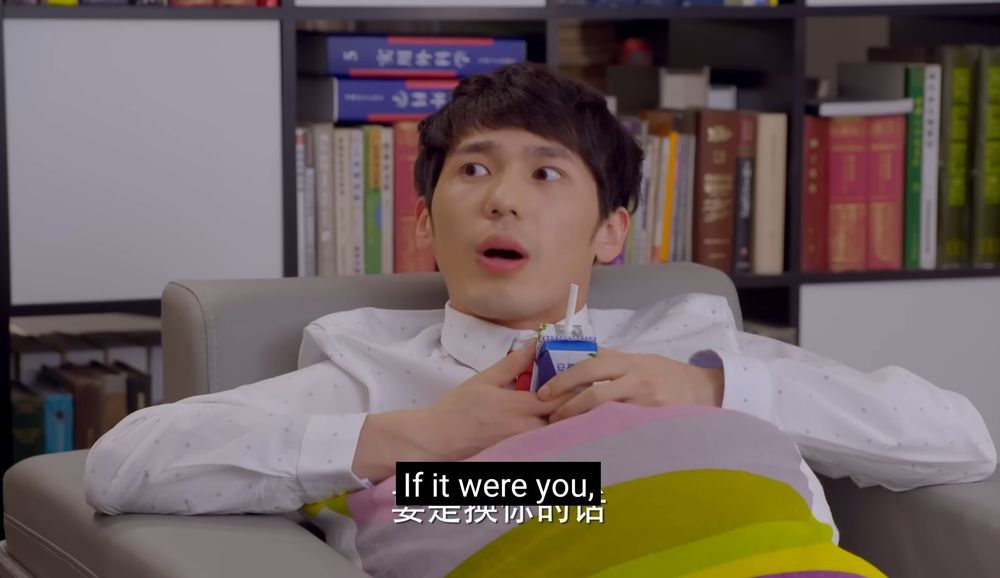 Screenshot from an episode of Grow Up. Xie Nanxiang slouched down in an armchair looking to his side with a surprised expression on his face