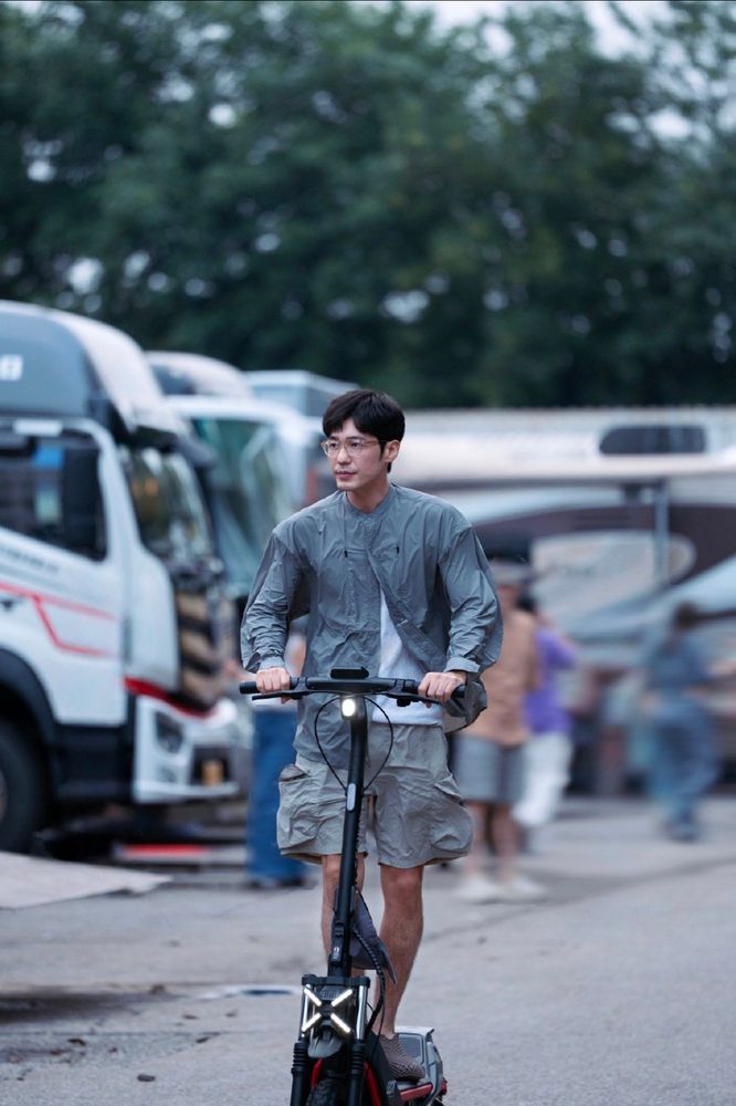 Bai Yu speeding along on an electric scooter