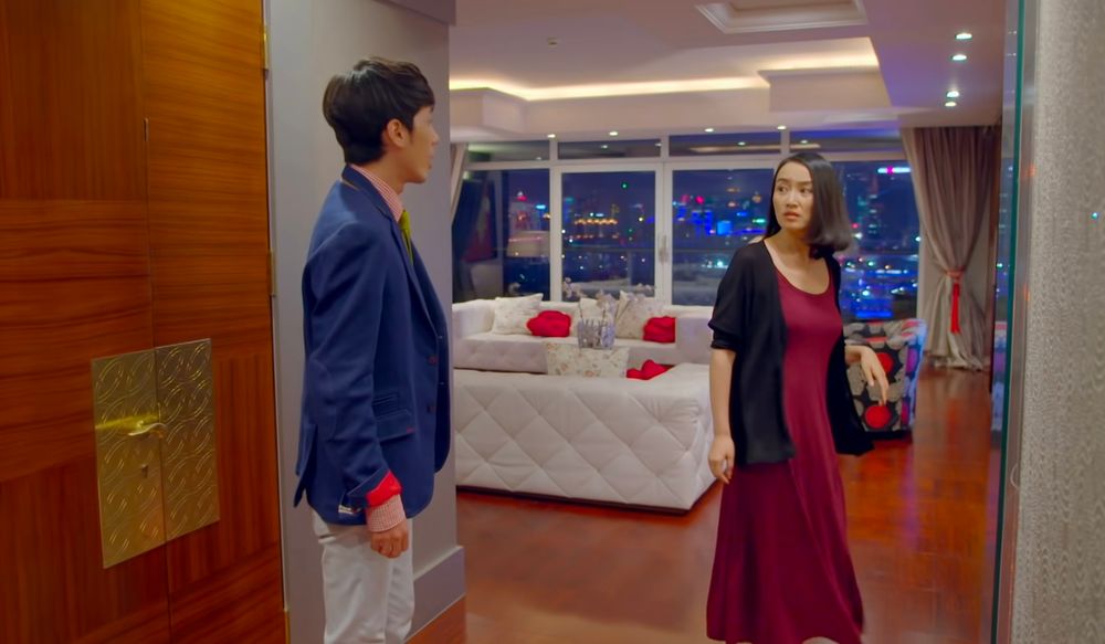 Xie Nanxiang stood in Dr Lin's apartment by the door, she is turning away from him to walk to another room his rolled up jacket cuff is showing its bright red lining 