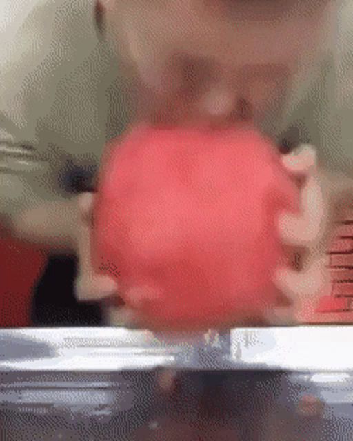 a close up of a person holding a red apple