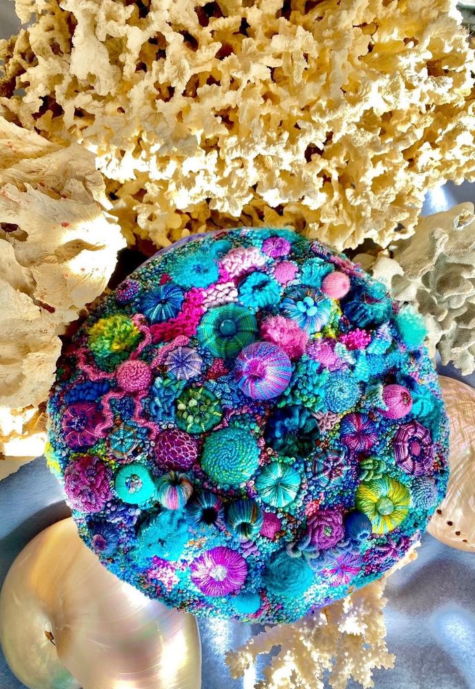 Bright. circular embroidered coral reef.